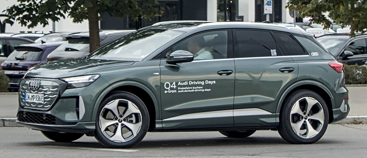 Audi Q4 e-tron performance electric SUV exterior, front three-quarter view.