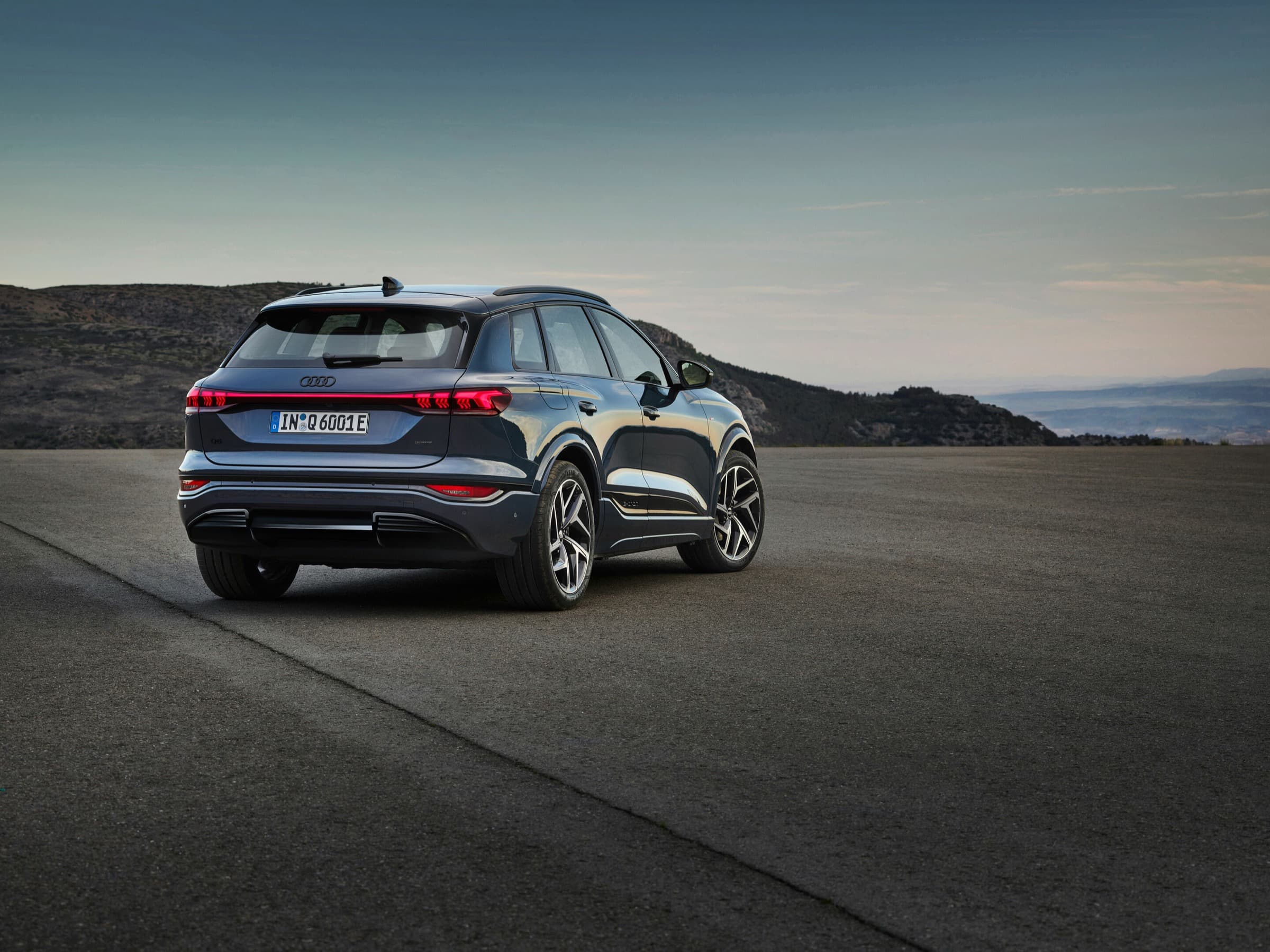 Audi Q6 e-tron Performance electric SUV exterior, rear three-quarter view.