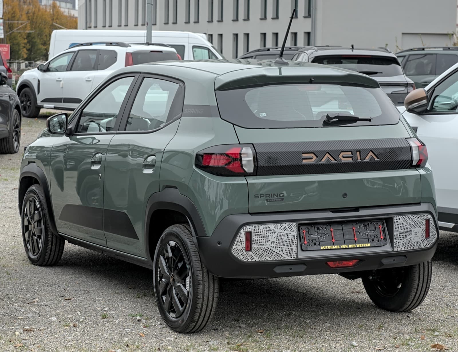 Dacia Spring Electric 100 electric hatchback exterior, rear three-quarter view.