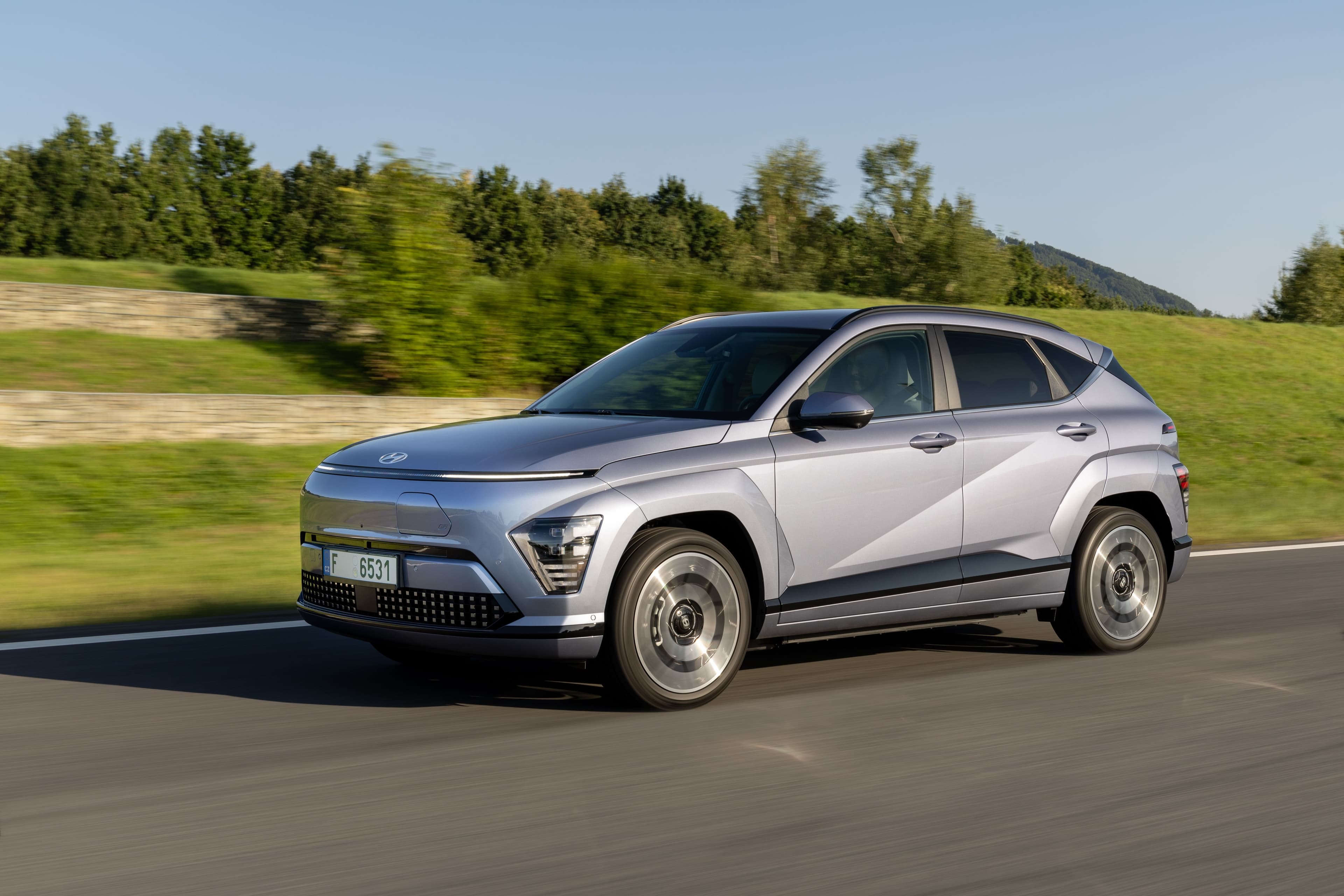 Hyundai Kona Electric 65 kWh electric crossover exterior, front three-quarter view.
