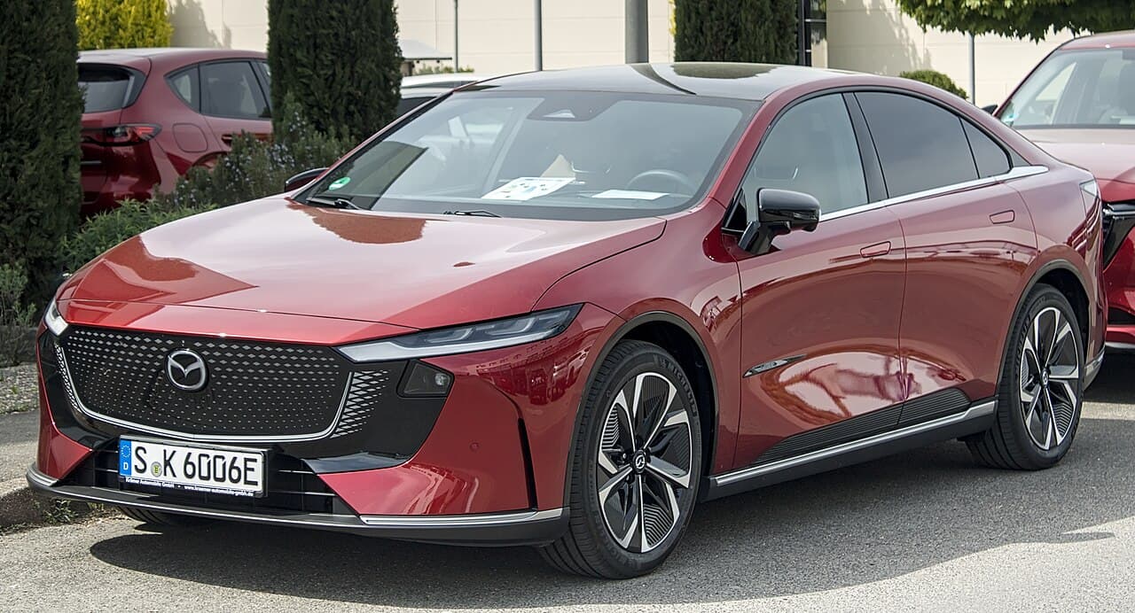 Mazda 6e 78 kWh electric liftback sedan exterior, front three-quarter view.