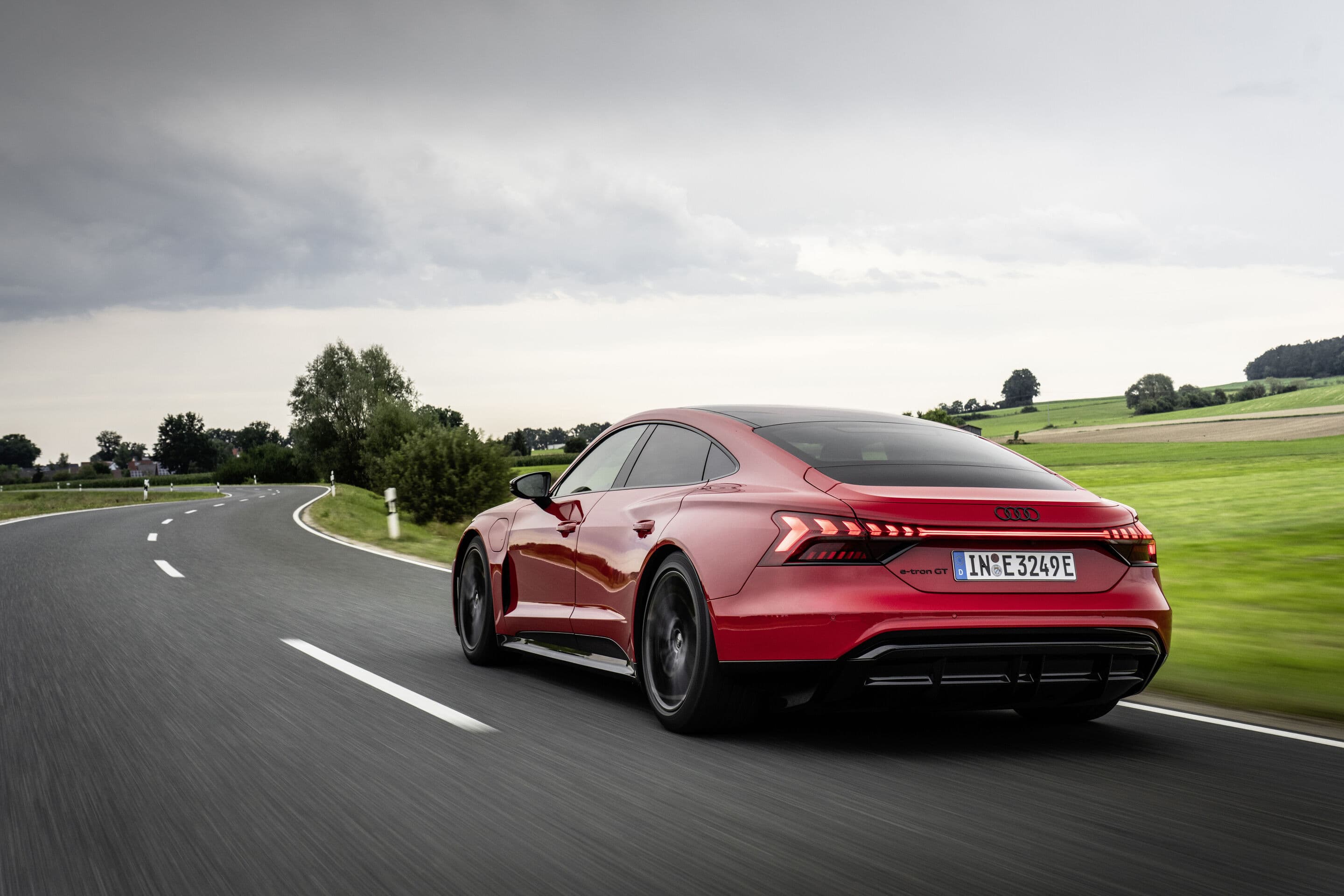 Audi e-tron GT quattro electric sedan exterior, rear three-quarter view.
